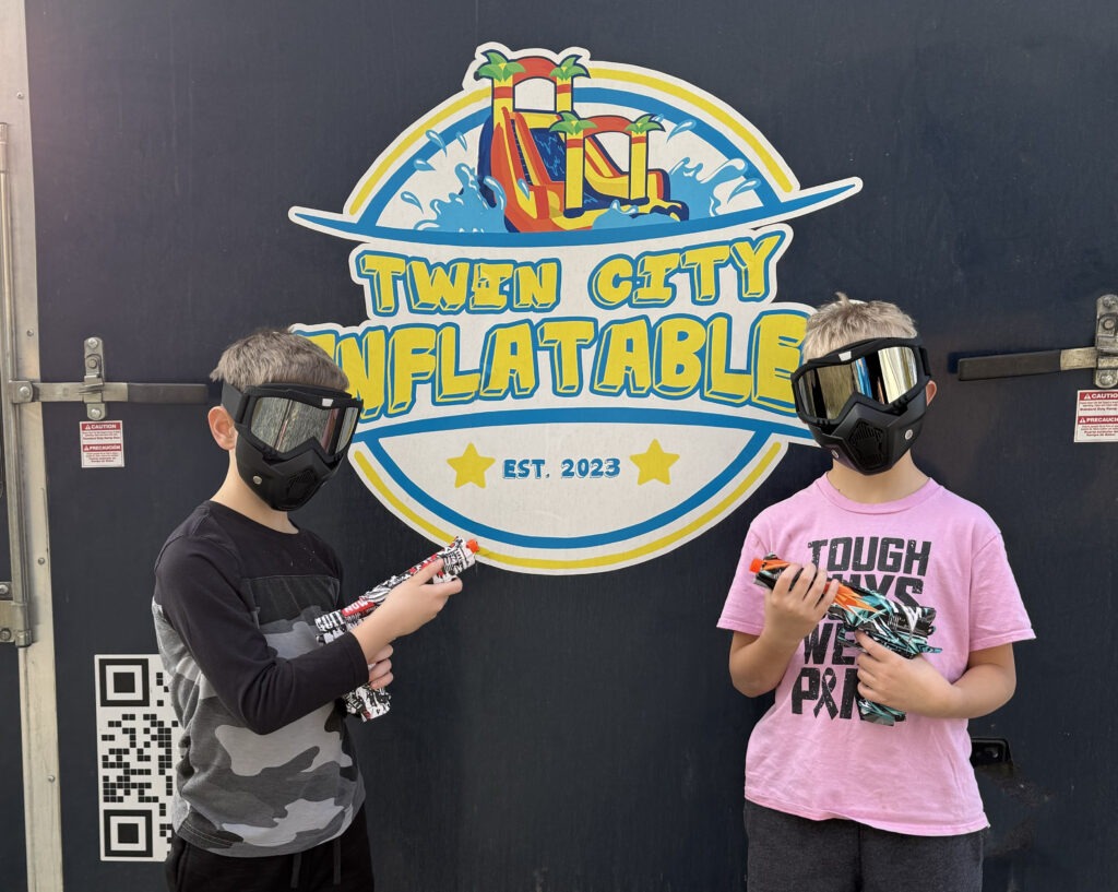 Two Boys Wearing Face Masks and Holding Gel Shooters | Ultimate Party Battles by Twin City Inflatables